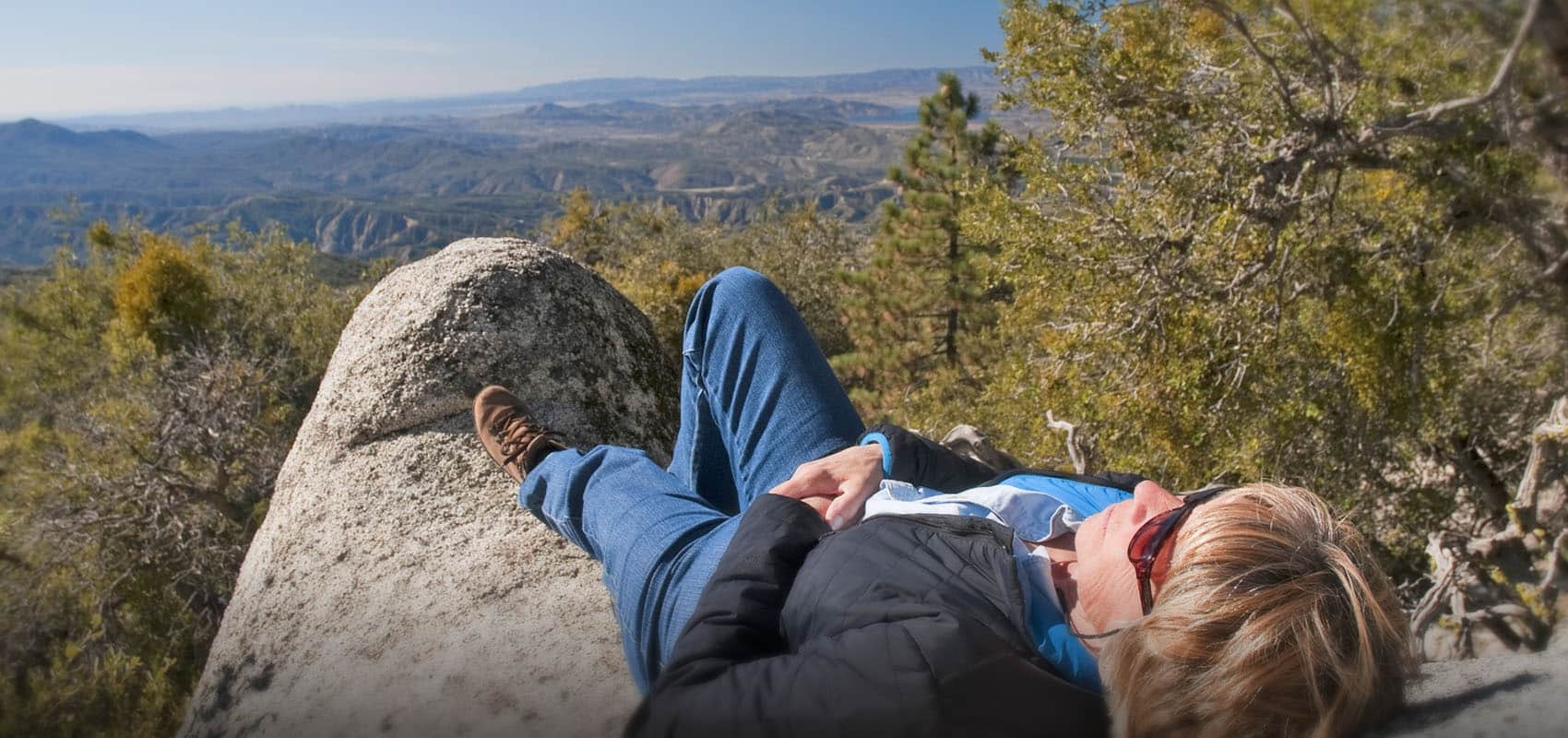 Woman resting on rock